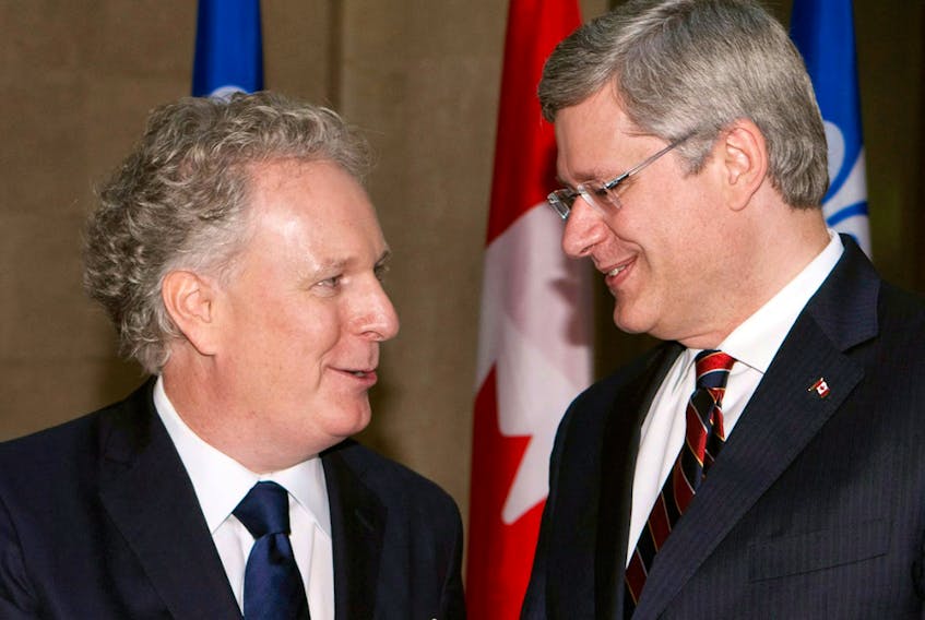 Stephen Harper is greeted by Jean Charest in 2011. The two have history.