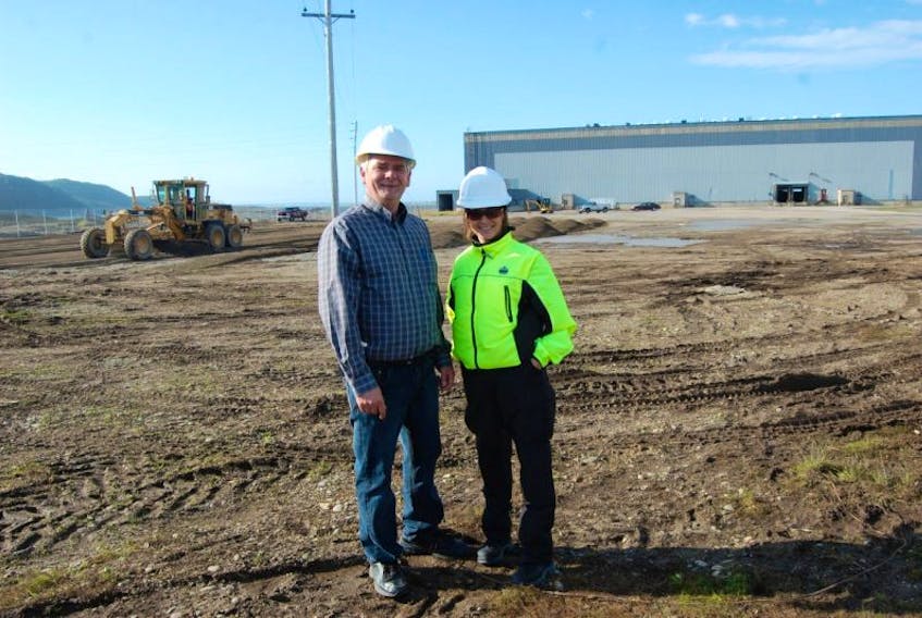 With construction work taking place behind them, Mayor Tom O’Brien is seen with Linda Marche, a security guard at the Stephenville Port Harmon Industrial Facility, formerly known as the paper-shed. <br /><br /><br />