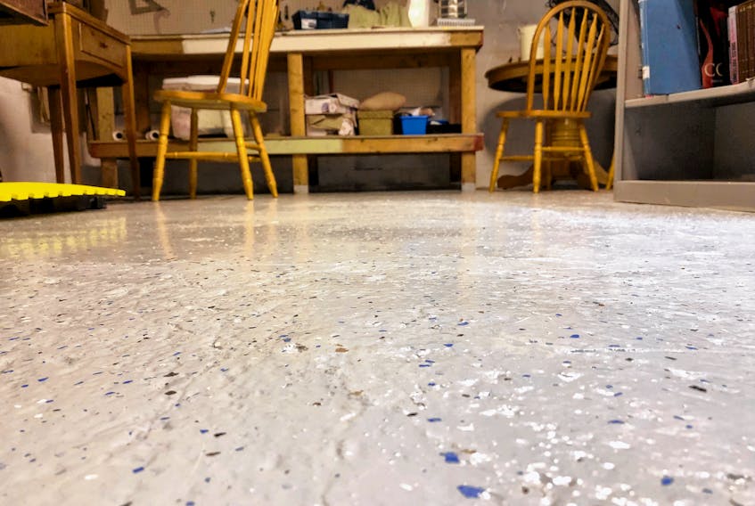 A few hours work rolling on an epoxy floor coating can make any unfinished basement much more inviting. The plastic flakes are added after application but before the epoxy has cured.