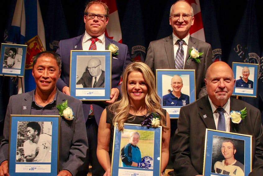 The St. F.X. Sports Hall of Fame inducted its Class of 2019 during Homecoming weekend on the Antigonish campus. Dave Liem (soccer), Dr. Beth McCharles (soccer and hockey), Andy Culligan (hockey), Bart Sears (back, left), who represented his grandfather and builder Dr. Cecil MacLean, and Dr. David Cudmore (builder) were the inductees. St. F.X. Athletics