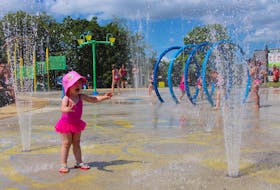 It was two-year-old Abigail Munroe’s first time at the splash pad in Bannerman Park on Saturday and her mother, Michelle Coffill, figured she was going to have a fight on her hands when it was time for the family to leave. Abigail twisted, wiggled and flapped her arms, all while standing in the same spot. She stared at the water, fascinated, as it rose out of the ground and into the air, before coming back down again. Her twin sister, Laura, also sporting a pink tutu, was more interested in chasing the birds around the park. – Andrew Waterman/The Telegram