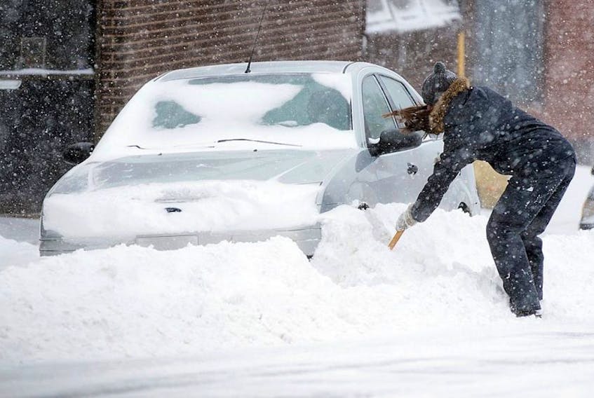 <span>A motorist digs out a car in Halifax on Saturday, March 5, 2016. Heavy snow and winds are buffeting parts of Nova Scotia with zero visibility and poor travel conditions.</span>