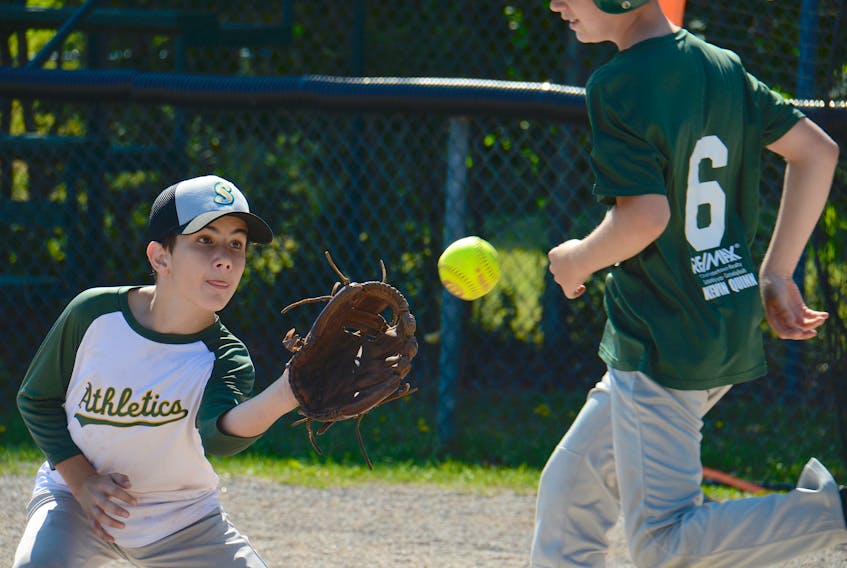 Daniel Ferguson prepares to catch the ball while covering first base on a bunt during a recent Kevin Quinn Re/Max Stratford Stealers boys’ softball team practice.