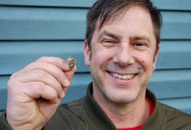 Colin Burke of Stratford holds up his graduation ring that he lost shortly after graduating from Charlottetown Rural high school in 1989. A plumber found the ring earlier this month in the toilet of a home where Burke used to live.
