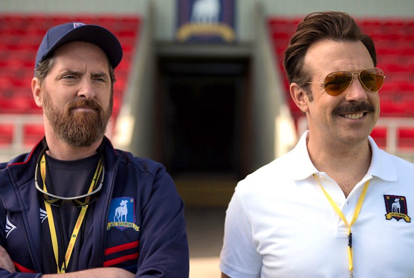 Brendan Hunt and Jason Sudeikis monitor the team’s progress in Ted Lasso. The first season is now streaming on Apple TV Plus. APPLE