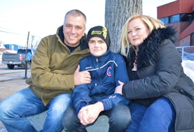 Chase MacNeil, 14, centre, who was violently attacked at Riverview High School Wednesday in an incident caught on video, relaxes in Sydney on Friday with his parents, father Craig MacNeil, of Howie Centre and mother Tricia MacNeil of Westmount. Chase said he’s still a little upset over the ordeal and is still sore and although doesn’t know yet when he’ll be returning to school, doesn’t feel he’ll be scared to go back as he knows there’s a lot of support out there for him and it’s making him feel good. Sharon Montgomery-Dupe/Cape Breton Post