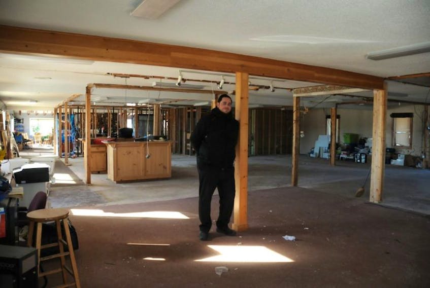 <p>Brad Cook, resident pro and manager of the Summerside Golf and Country Club, looks over the hollowed shell of the clubhouse. The facility’s new owner recently started renovations to the building, which he plans to complete in time for a grand opening this spring.&nbsp;</p>