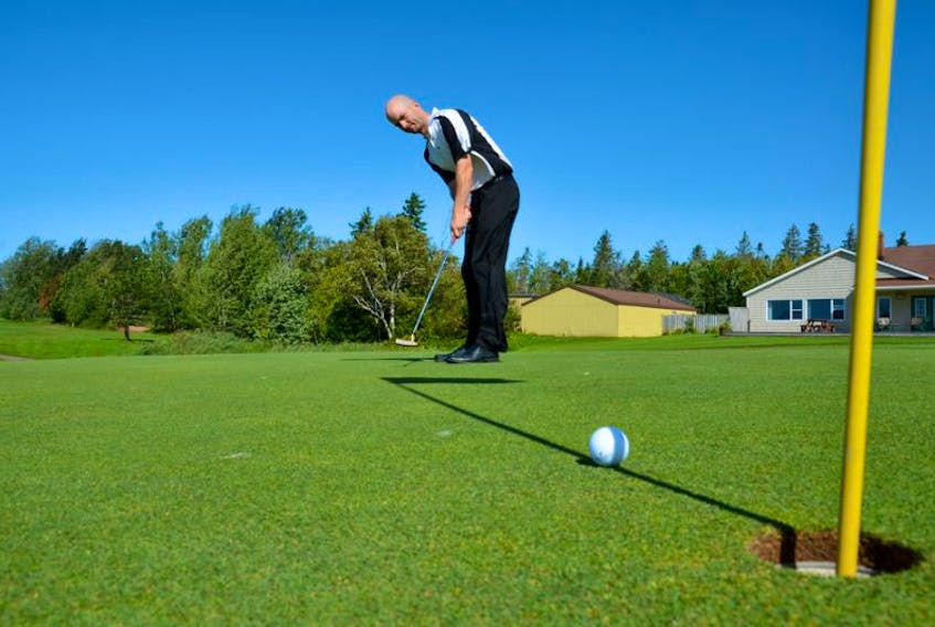 FILE PHOTO: Dallas Desjardins makes a putt on the 18-hole at <span class="Normal">Summerside Golf and Country Club</span>.