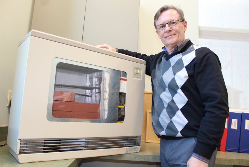 Colin MacLean/Journal Pioneer
Bobby Dunn, manager of Summerside's Heat for Less program, with one of the demo electric thermal storage units sold by Summerside Electric. A group in Yukon is looking to start offering the same kind of heaters and is looking to Summerside for guidance. 