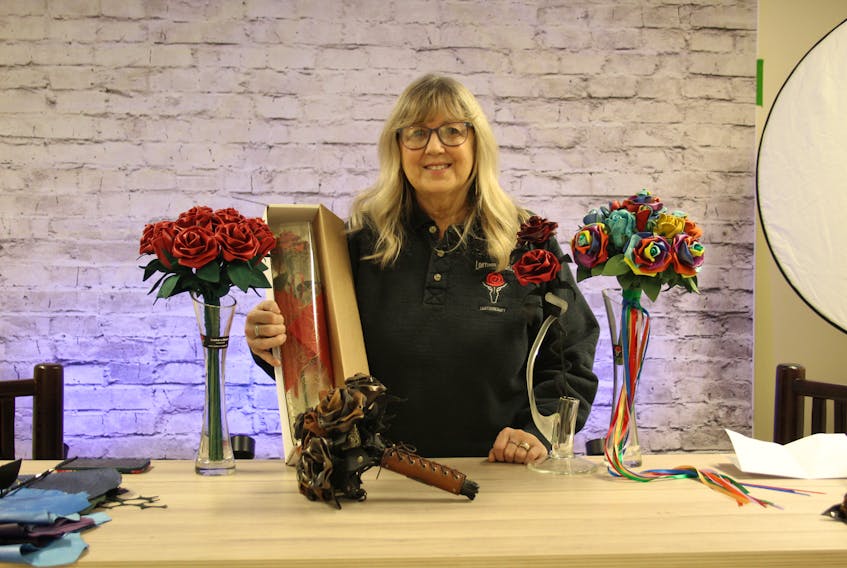 Janet Dodson, along with all the different styles of roses she makes, from classic red roses to rainbow roses for pride month.