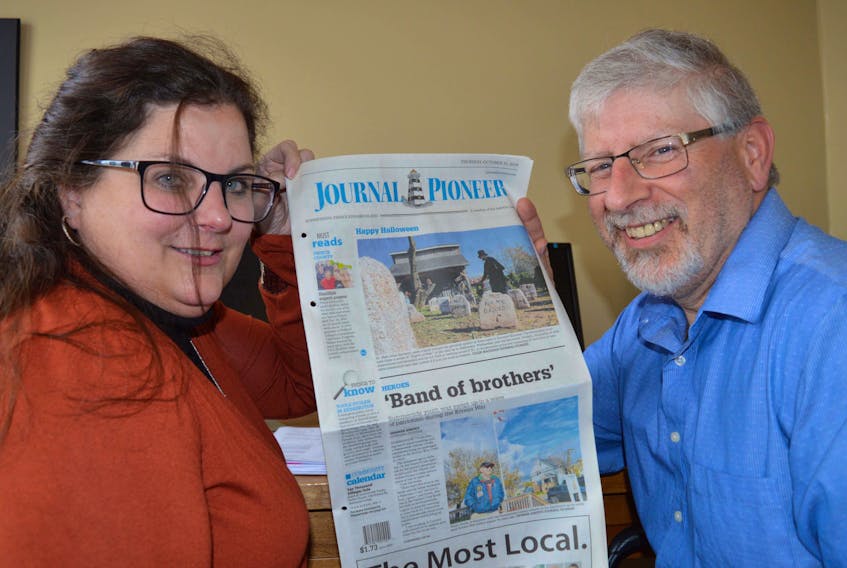 Traci Gaudet, multimedia sales consultant, and Ron Lund, regional circulation director, look over a past edition of the Journal Pioneer. The Summerside newspaper is coming back as a weekly publication in November. Alison Jenkins/Local Journalism Initiative Reporter