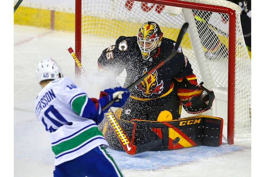  Calgary Flames goalie Jacob Markstrom stops Vancouver Canucks star Elias Pettersson in second-period action at the Scotiabank Saddledome in Calgary on Wednesday, February 17, 2021. Darren Makowichuk/Postmedia