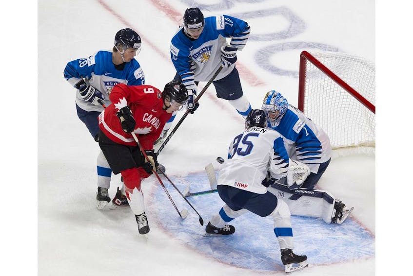 Canada's Connor Zary -- a Calgary Flames prospect -- is on the doorstep of Finland goalie Kari Piiroinen as he is surrounded by Kasper Puutio, Henri Nikkanen and Mikko Kokkenen during IIHF World Junior Hockey Championship action on Thursday in Edmonton. Photo by Greg Southam/Postmedia
