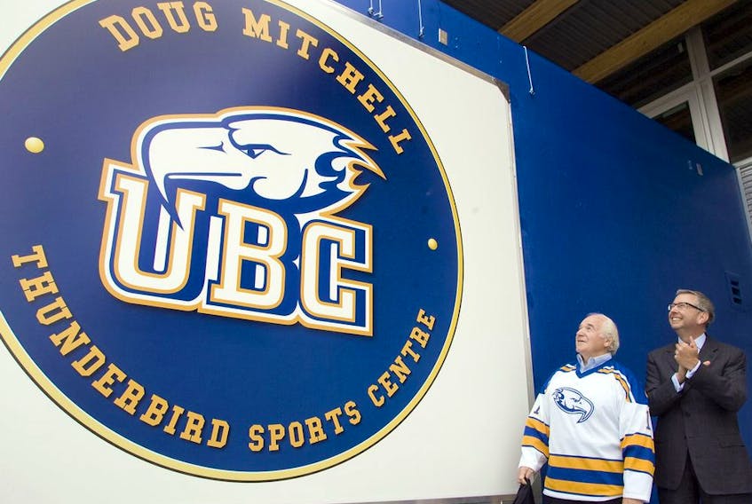 Doug Mitchell and former UBC President Prof. Stephen J. Toope look at the new logo for the Doug Mitchell Thunderbird Sports Centre after the unveiling ceremony in Vancouver. Friday, August, 21, 2009