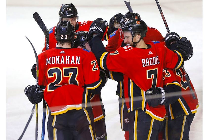Calgary Flames defenceman T. J. Brodie celebrates his OT winner on Columbus Blue Jackets goalie Joonas Korpisalo in NHL action at the Scotiabank Saddledome in Calgary on Wednesday. Photo by Darren Makowichuk/Postmedia.