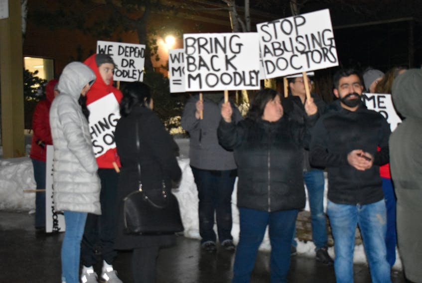 A group of supporters of Dr. Manivasan Moodley attend a rally outside of the Cape Breton Regional Hospital in Sydney on Thursday. About 50 people attended the rally, despite bitter cold winds. NIKKI SULLIVAN/CAPE BRETON POST 