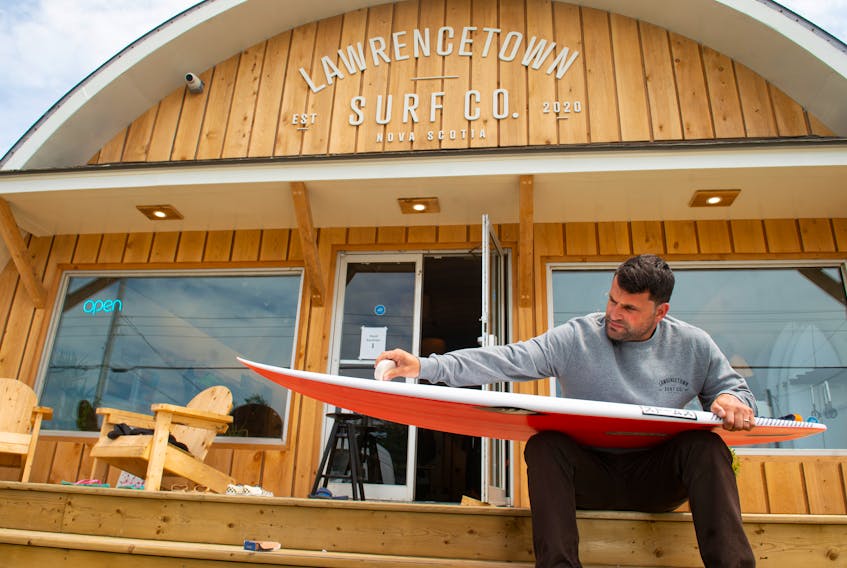 Nico Manos, co-owner of Lawrencetown Surf Co., waxes a board in front of his new surf shop on Monday, July 13, 2020.
Ryan Taplin - The Chronicle Herald