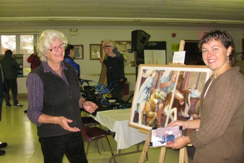 Canning artist Susan Gibson Garvey, left, and contributing Digby artist Poppy Balser compare watercolour sketches made Oct. 24. CBC host Don Connolly is shown in the background.