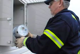 ['Summerside Electric employee Larry Blacquiere installs a smart metre on a city building. The Smart Grid technology is cited as one of the reasons why Summerside received first place for sustainability in Atlantic Business Magazine’s 2012 Corporate Social Responsibility awards.']
