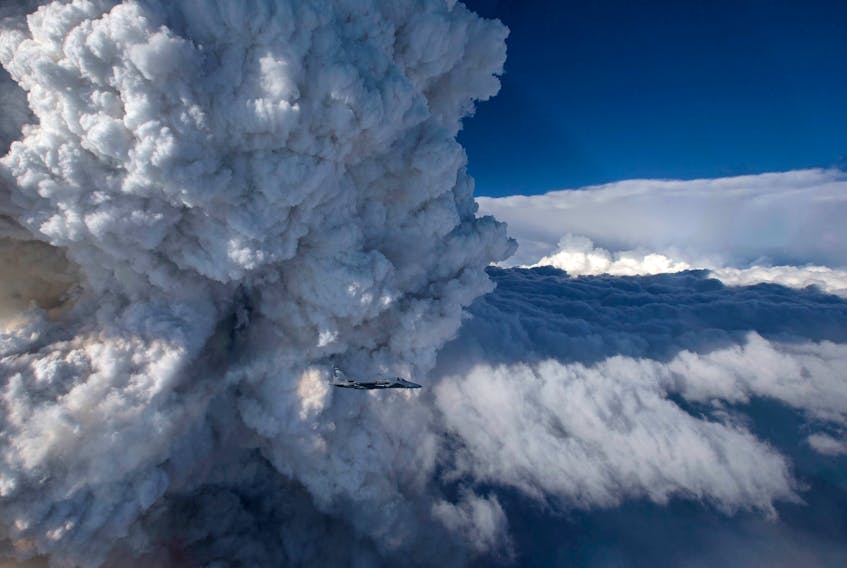 This photograph provided by NASA shows a developing pyrocumulus cloud above the Oregon Gulch fire, a part of the Beaver Complex fire in California. They were taken from an Oregon Air National Guard F-15C by James Haseltine on July 31, 2014.