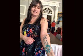 Cindy Ryan of Westville, Pictou County, shows off a tattoo she had done to pay homage to the two people who donated their organs upon their death. She was in attendance at a press conference to introduce the Human Organ and Tissue Donation Act. Ryan needed a liver transplant in 2013, but had complications. She received a second one in 2015. The act would presume everyone to be a potential donor unless they or their family opts out.