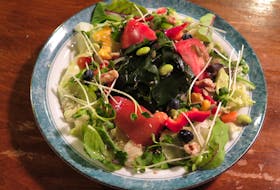 A wakame and lettuce salad with seaweed, beans, and tomatoes. - Douglas Perkins