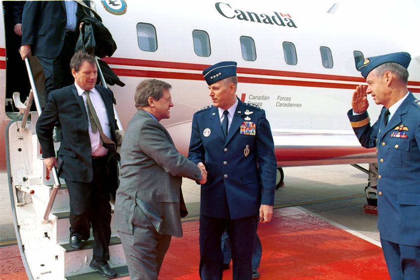 Former Foreign Affairs minister Lloyd Axworthy, left, is greeted by U.S. Air Force General Richard Myers at Peterson Air Force Base in Colorado in this 1999 file photo.