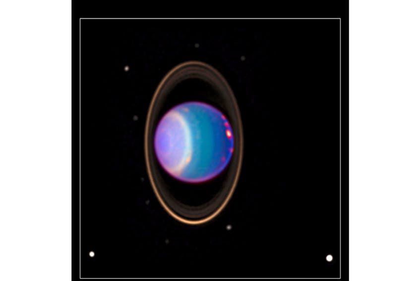 A Hubble Space Telescope view reveals Uranus surrounded by its four major rings and by 10 of its 17 known satellites. This false-color image was generated in 2000 by Erich Karkoschka, using data taken Aug. 8, 1998, with Hubble's near infrared camera and multi-object spectrometer.