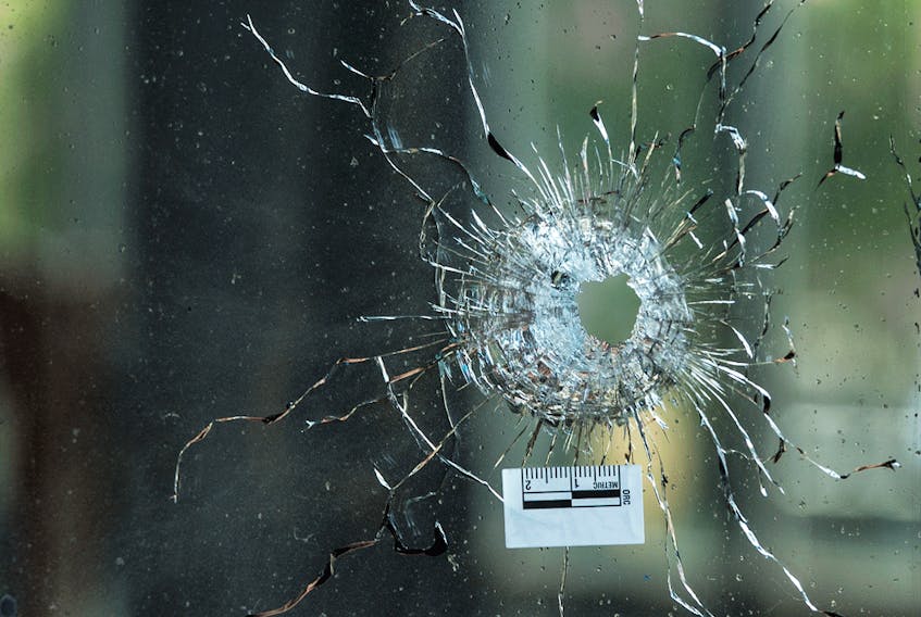 A bullet hole through a glass window is seen at Pappas Grill on Danforth Avenue in Toronto the day after a mass shooting on July 22, 2018. - Peter J. Thompson