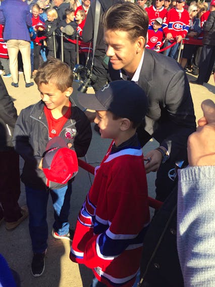 Montreal Canadiens Jesperi Kotkaniemi poses for photo with young fans in Bathurst.
