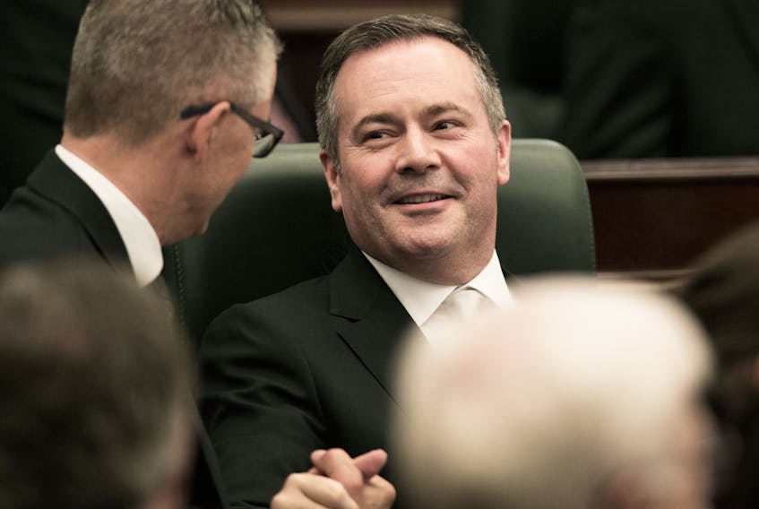 Alberta Premier Jason Kenney is congratulated by Finance Minister Travis Toews following the opening of the first session of the 30th Alberta Legislature, in Edmonton, May 22, 2019. - David Bloom/Postmedia