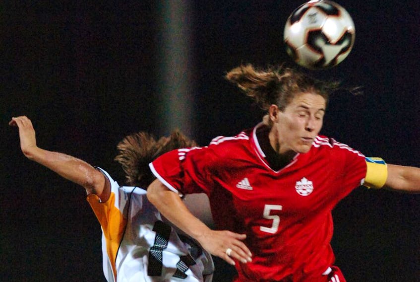 Canada's Andrea Neil gets her head on the ball vs  Germany in Women's International Soccer during her career. - Arlen Redkop