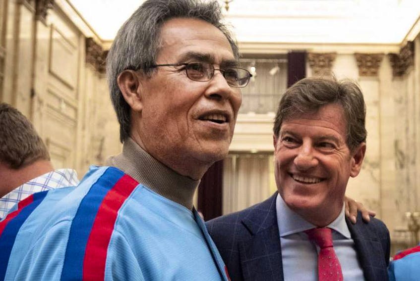 Dennis Martinez greets Stephen Bronfman as a group of former Montreal Expos visit city hall in Montreal, on Monday, March 25, 2019.