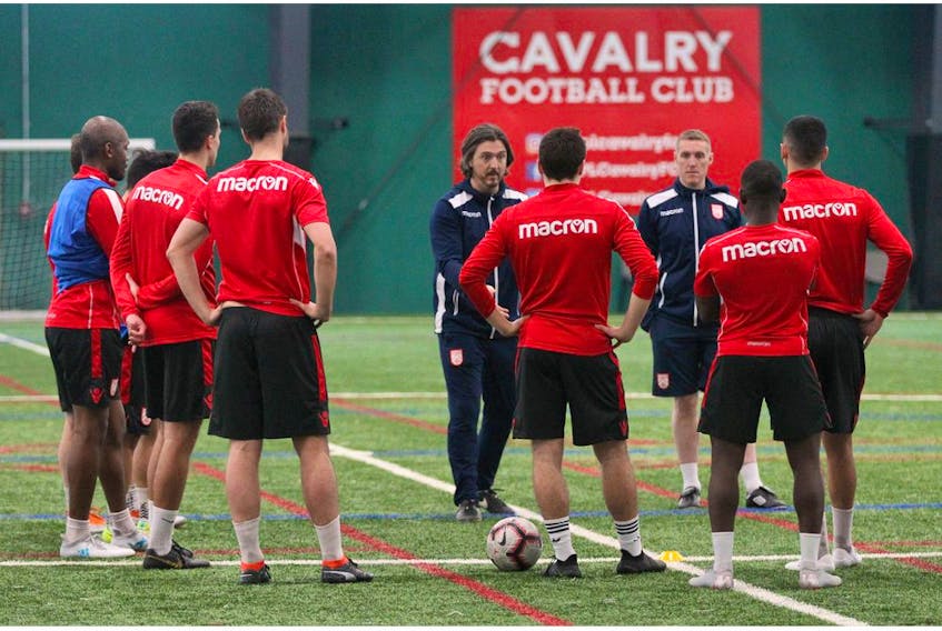 Cavalry FC head coach Tommy Wheeldon Jr (left) and assistant coach and technical director Martin Nash, speak to the team during a training session at the Foothills Fieldhouse in Calgary, AB on Monday, March 25, 2019. Jim Wells/Postmedia