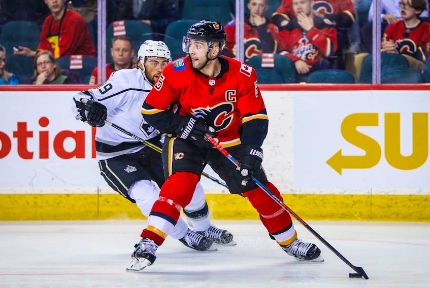 Calgary Flames defenseman Mark Giordano (5) controls the puck against the Los Angeles Kings during the second period at Scotiabank Saddledome. - Sergei Belski-USA TODAY Sports