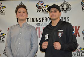 Denis Kypr, a Grade 11 student at Sydney Academy originally from Brno, Czech Republic, is shown with boxer Vladimir Reznicek of Prague on Wednesday following a press conference for the Valentine’s Day Massacre fight card at Centre 200. CAPE BRETON POST PHOTO