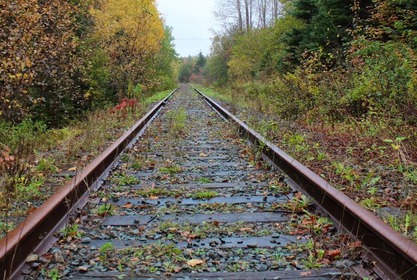 Fall colours and falling leaves frame this portion of the Cape Breton and Central Nova Scotia Railway in Balls Creek from October 2019. The promoters of a proposed Sydney harbour container port say rehabilitating the dormant railway is the last hurdle facing the development.  GREG MCNEIL/CAPE BRETON POST 
