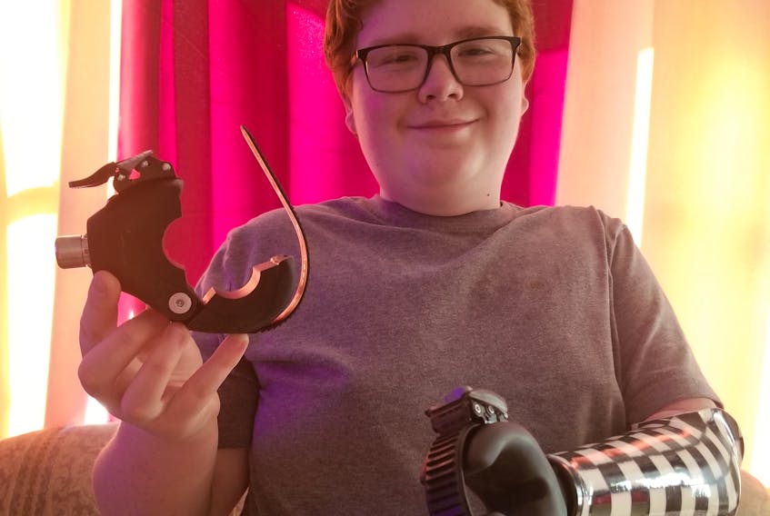 Zakk McDonald shows the new weightlifting device he was equipped with thanks to the War Amps Child Amputee — or CHAMP — Program. The 14-year-old Sydney resident was born missing his left arm. Contributed/ Patsy MacInnis