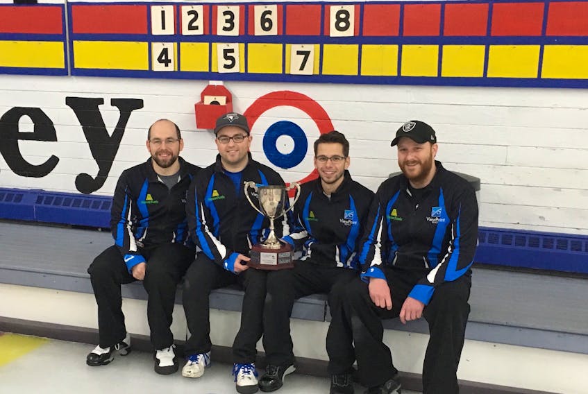 Members of Team Roach sit in front of the scoreboard with the trophy they received for winning the 2018 Nova Scotia Travelers Club Curling championship at the Sydney Curling Club. The Kurt Roach-skipped foursome were runners-up at the national championship two years ago and are returning to the provincial competition in hopes of winning the title for a third time. The Sydney rink, from left, lead Robin Nathanson second Travis Stone, third Mark MacNamara and skip Kurt Roach, kicks off the five-day 2020 competition at the Bridgewater Curling Club today. The winning team will be determined Monday and will earn entry to the Canadian club curling championships in Ottawa in November. DAVID JALA/CAPE BRETON POST