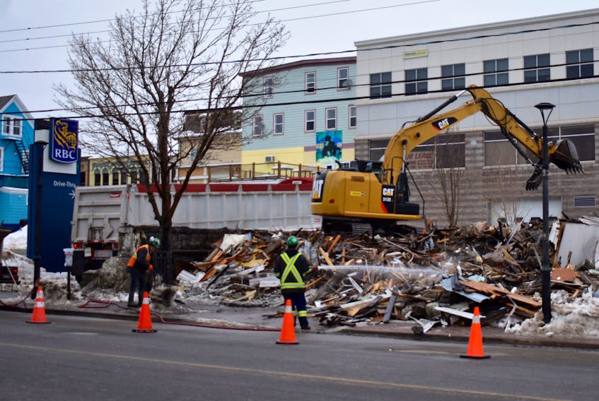 An excavator rips apart a 130-year-old building that was home to Vance MacCormack for more than 80 years. The 82-year-old former Sears salesman vacated his lifelong home in November after mobility issues made living alone more challenging. He subsequently sold the building to Sydney businessman Martin Chernin. The structure whose civic address was 421 Esplanade in Sydney was razed on Sunday. David Jala photo