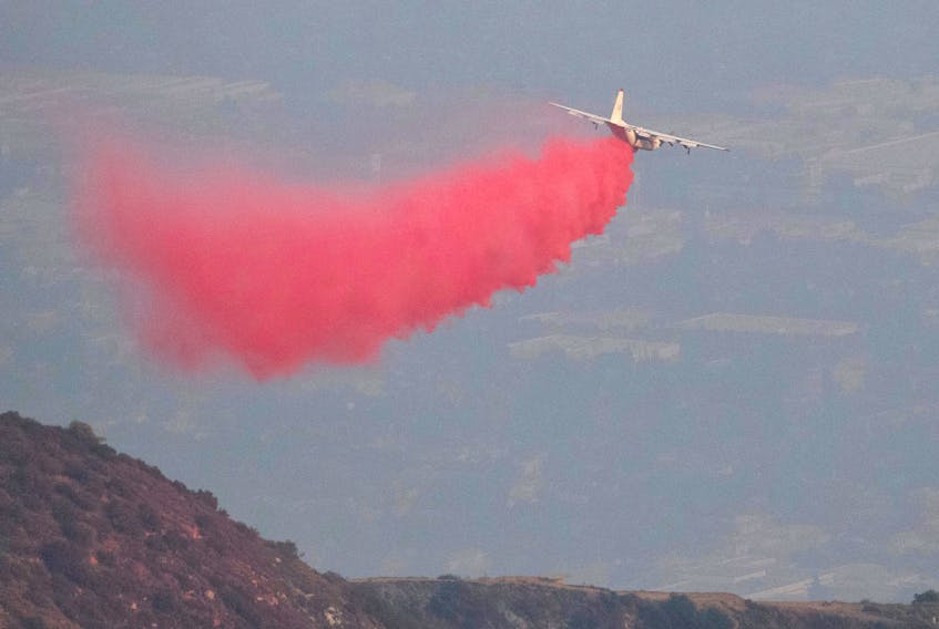 An air tanker drops fire retardant on a hill near Mount Wilson Observatory while battling the Bobcat Fire in Los Angeles on Monday. REUTERS/Mario Anzuoni
