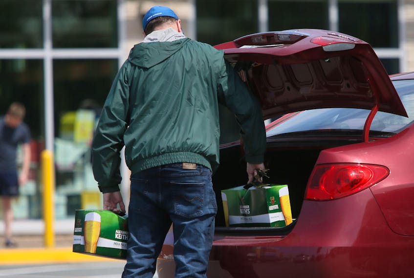 A man places a couple of cases of beer into his trunk after leaving an NSLC outlet in Dartmouth. TIM KROCHAK - The Chronicle Herald - File