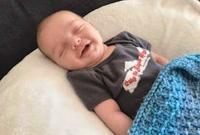 A baby wears one of the shirts that is being sold by Wendy Owens Abbott of St. Peter's to raise funds to purchase iPads to be used by residents of Richmond Villa to stay in touch with loved ones while in lockdown. Contributed