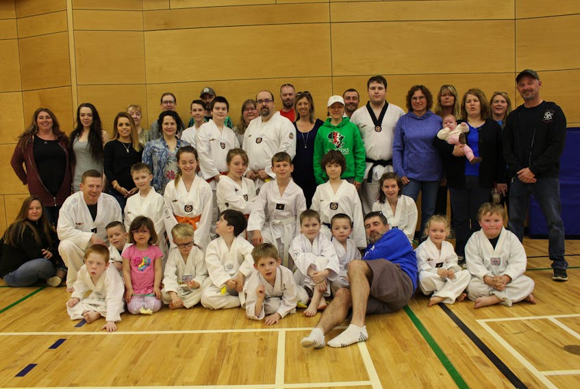 Tidal Spirit Taekwondo athletes, pictured here with some parents, recently won 45 medals at a tournament in Halifax.