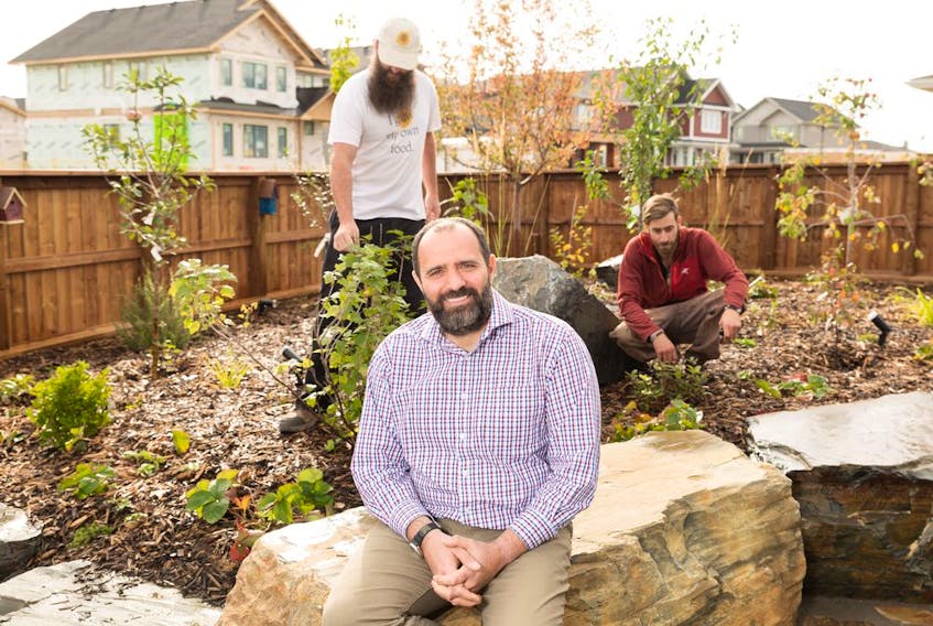 Tamer El-Masri in his edible garden with Jeremy Zoller from Sunshine Earth Works and  Brad Robertshaw from Adept.