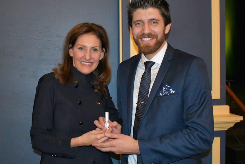 Barbara Stegemann presents Tareq Hadhad an gift of a chocolate-scented perfume at Game Changers, at the deCoste Performing Arts Centre on Thursday night.