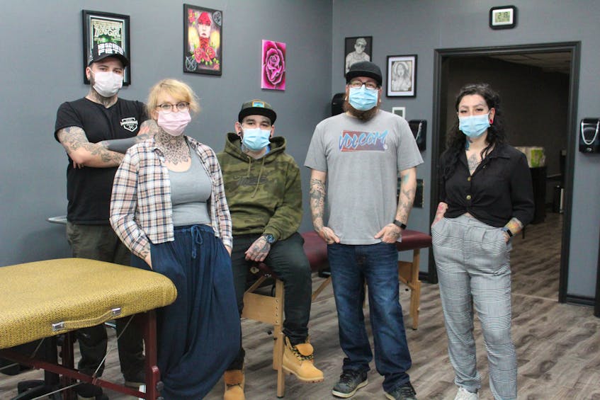 The tattoo and piercing artists at The 9th Gate Gallery in the Keltic Plaza in Sydney River in their shop on Saturday. The business has reopened following the COVID-19 shutdown. From left, front, Rinn Pollock, Luke Cormier and Jenna Hupola, back, Devin O'Brien and Frank Decker. NICOLE SULLIVAN/CAPE BRETON POST 