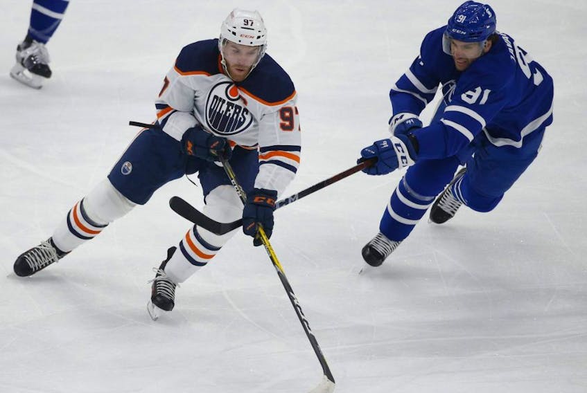 Toronto Maple Leafs John Tavares chases down Edmonton Oilers Connor McDavid in Toronto on Jan. 22, 2021.