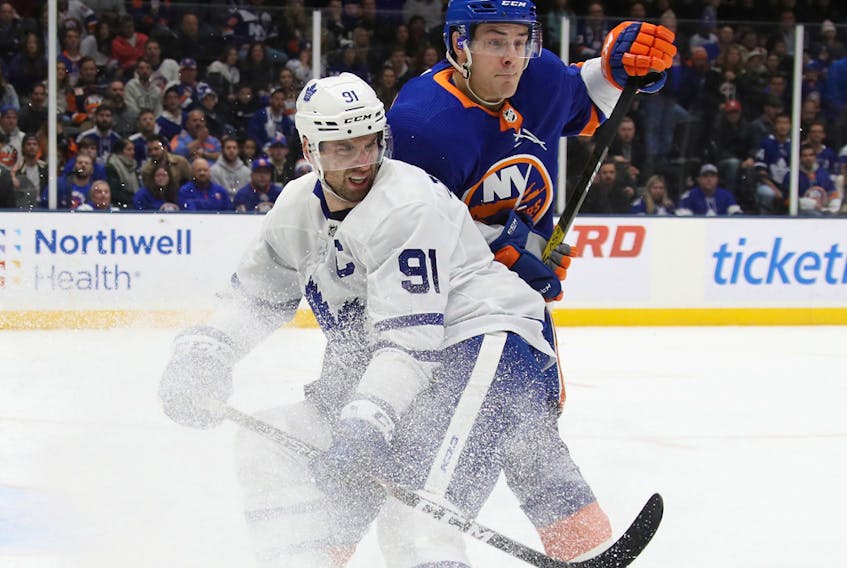 Mathew Barzal of the New York Islanders holds up John Tavares of the Toronto Maple Leafs during the second period at NYCB Live's Nassau Coliseum on Wednesday, Nov. 13, 2019 in Uniondale, N.Y. 