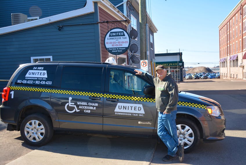 Myles Doucette, manager of United Summerside Taxi Inc., shows off one of the company’s wheelchair accessible vans outside the taxi stand. KATIE SMITH/JOURNAL PIONEER